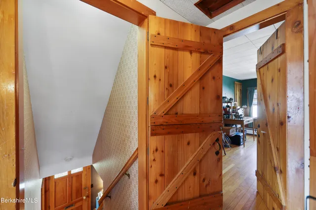 a view of entryway and hall with wooden floor