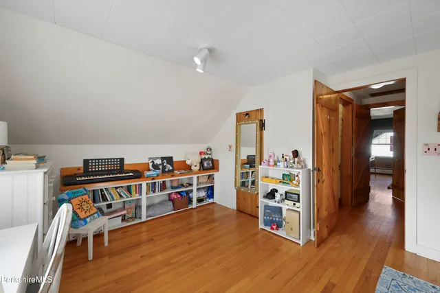 a view of a room with shelves and wooden floor