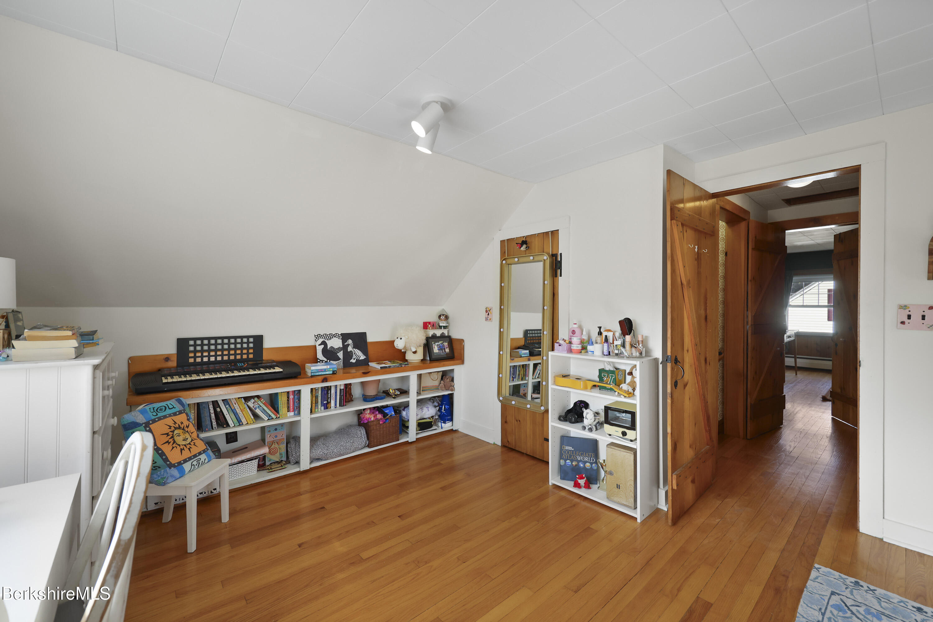 39 Lowden Street Pittsfield, MA 01201 - Photo 28 of 42 a view of a room with shelves and wooden floor