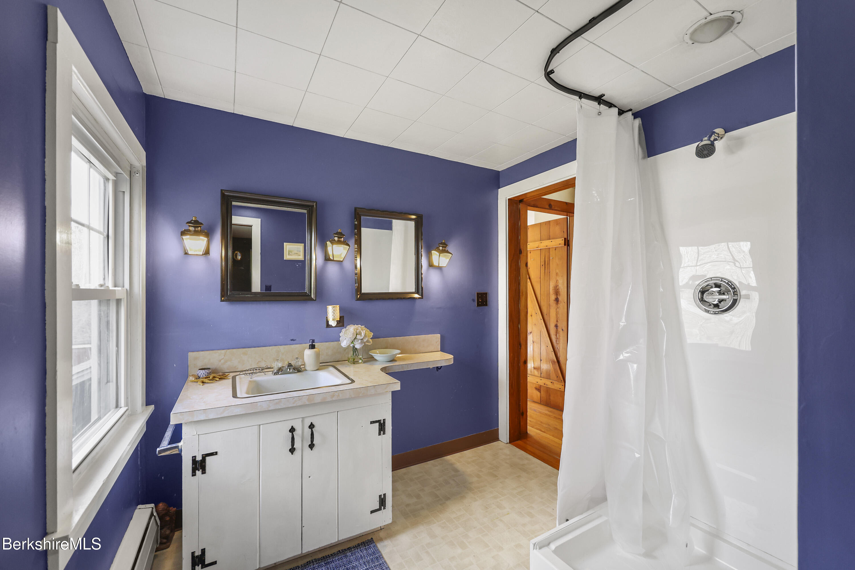 39 Lowden Street Pittsfield, MA 01201 - Photo 34 of 42 a bathroom with a sink a mirror and a shower