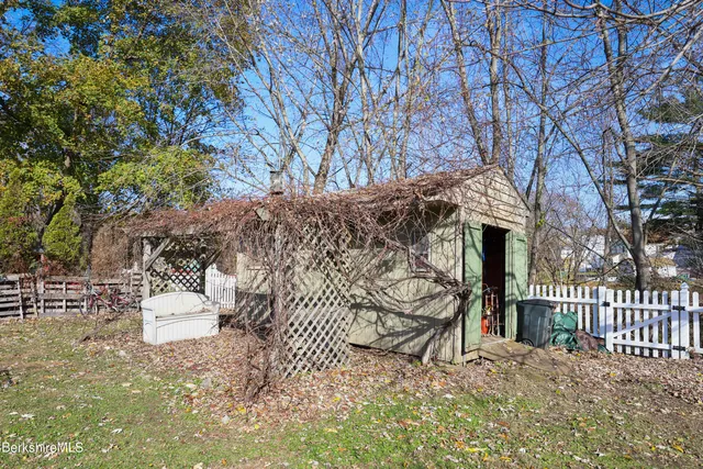 a wooden bench sitting in front of a building