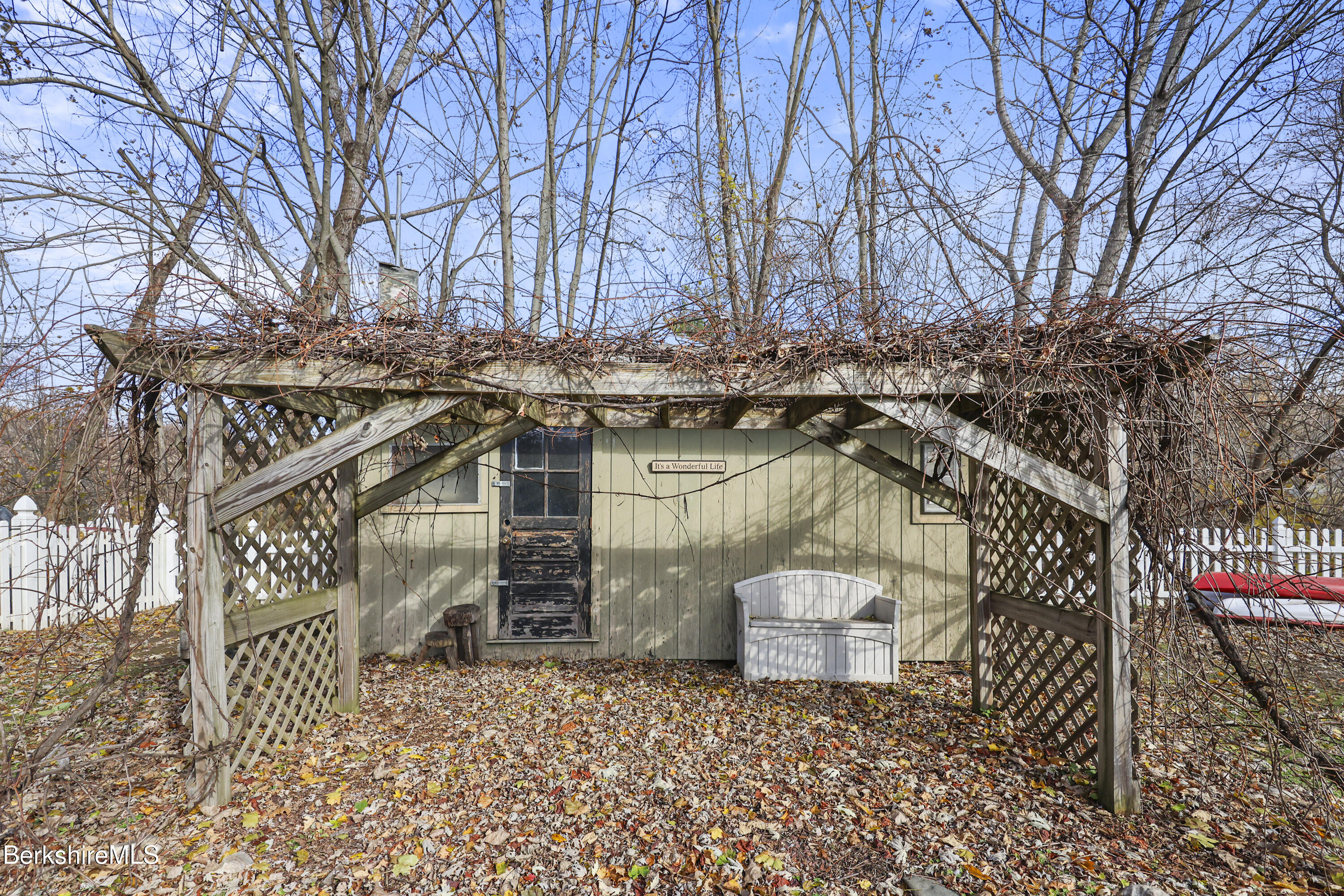 39 Lowden Street Pittsfield, MA 01201 - Photo 40 of 42 a view of a patio with wooden fence and a bench