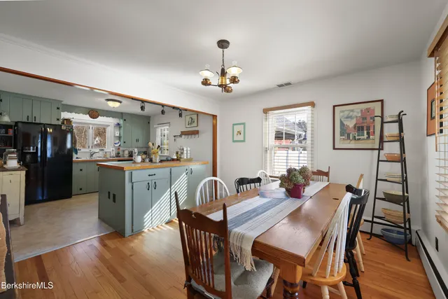 a view of a dining room with furniture wooden floor and a chandelier