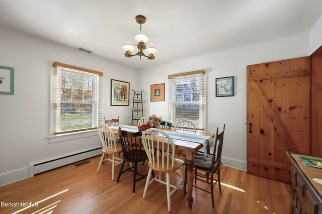 a view of a dining room with furniture wooden floor and a chandelier
