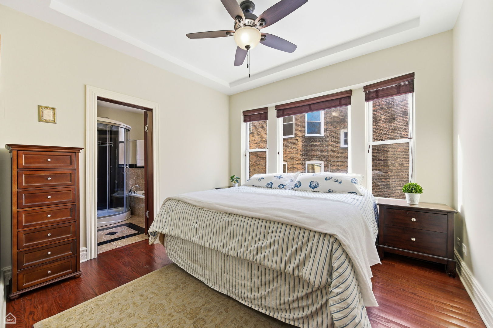 838 East 52nd Street, Unit 1W Chicago, IL 60615 - Photo 16 of 32 a bed sitting in a bedroom next to a window