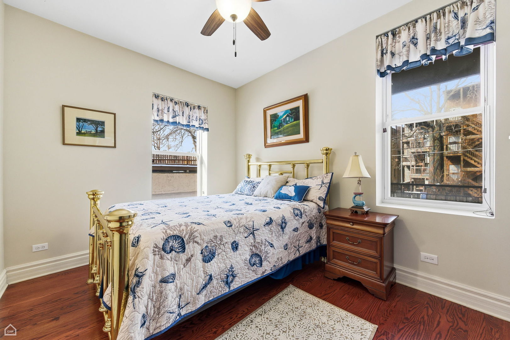 838 East 52nd Street, Unit 1W Chicago, IL 60615 - Photo 20 of 32 a bedroom with a bed paintings on the wall and a window