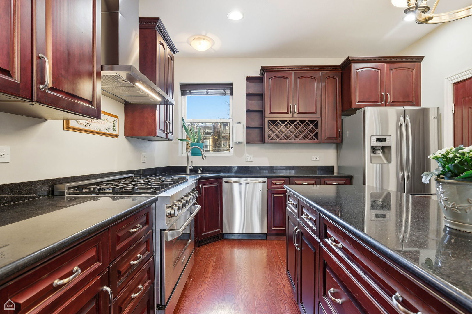 838 East 52nd Street, Unit 1W Chicago, IL 60615 - Photo 5 of 32 a kitchen with stainless steel appliances granite countertop a stove a sink and a refrigerator
