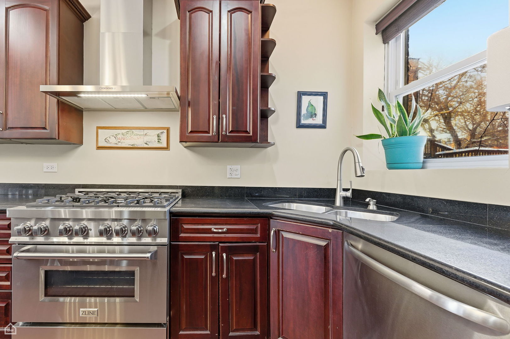 838 East 52nd Street, Unit 1W Chicago, IL 60615 - Photo 6 of 32 a kitchen with stainless steel appliances wooden cabinets and a stove top oven