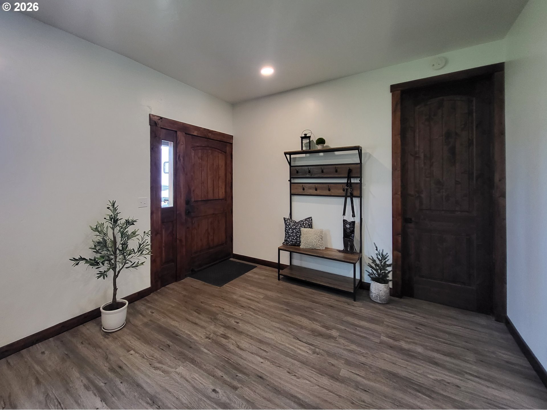 403 North Lake Street Joseph, OR 97846 - Photo 14 of 46 a hallway with a wooden floor and a potted plant