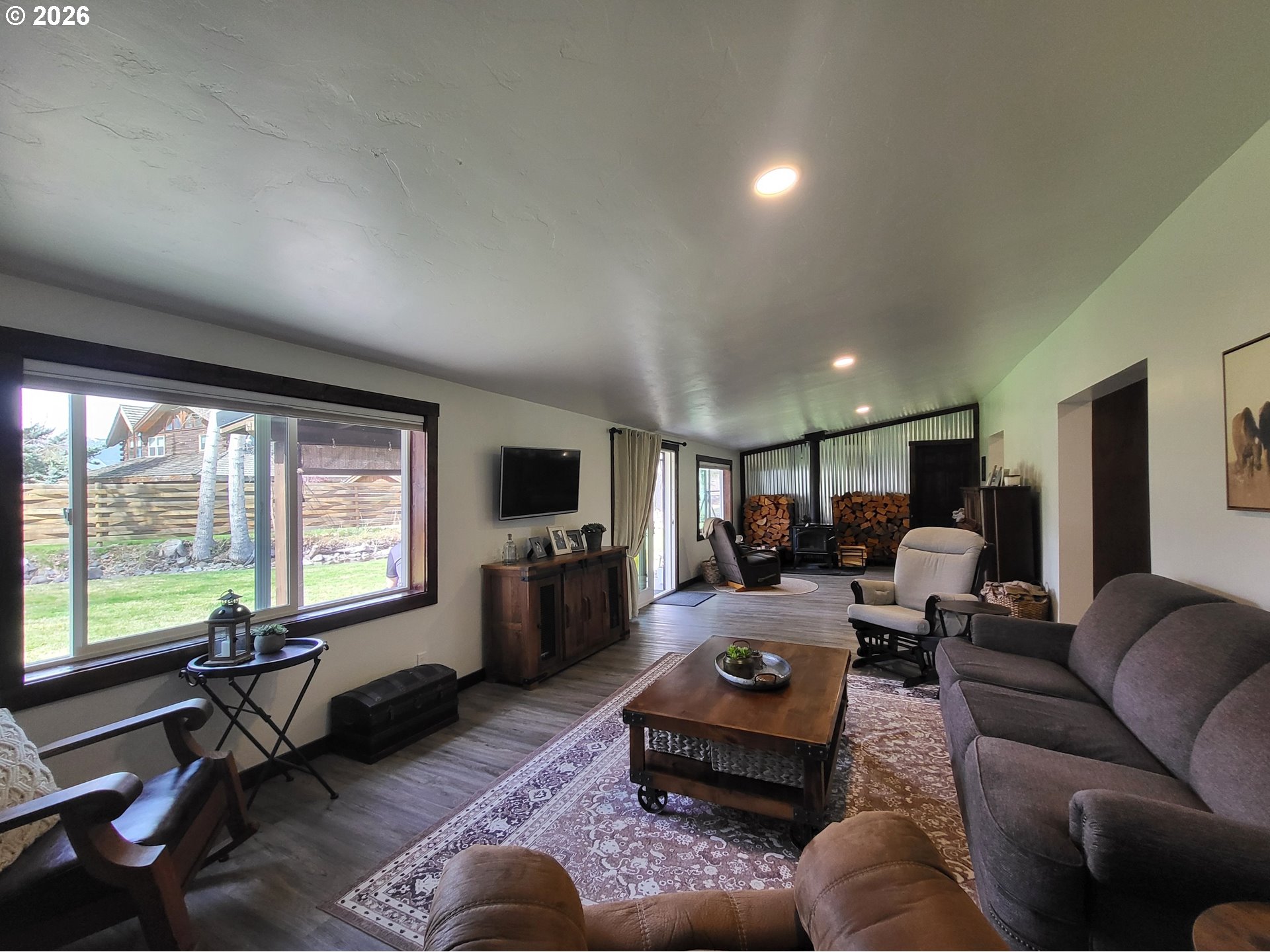 403 North Lake Street Joseph, OR 97846 - Photo 21 of 46 a living room with furniture floor to ceiling window hardwood floor and a flat screen tv