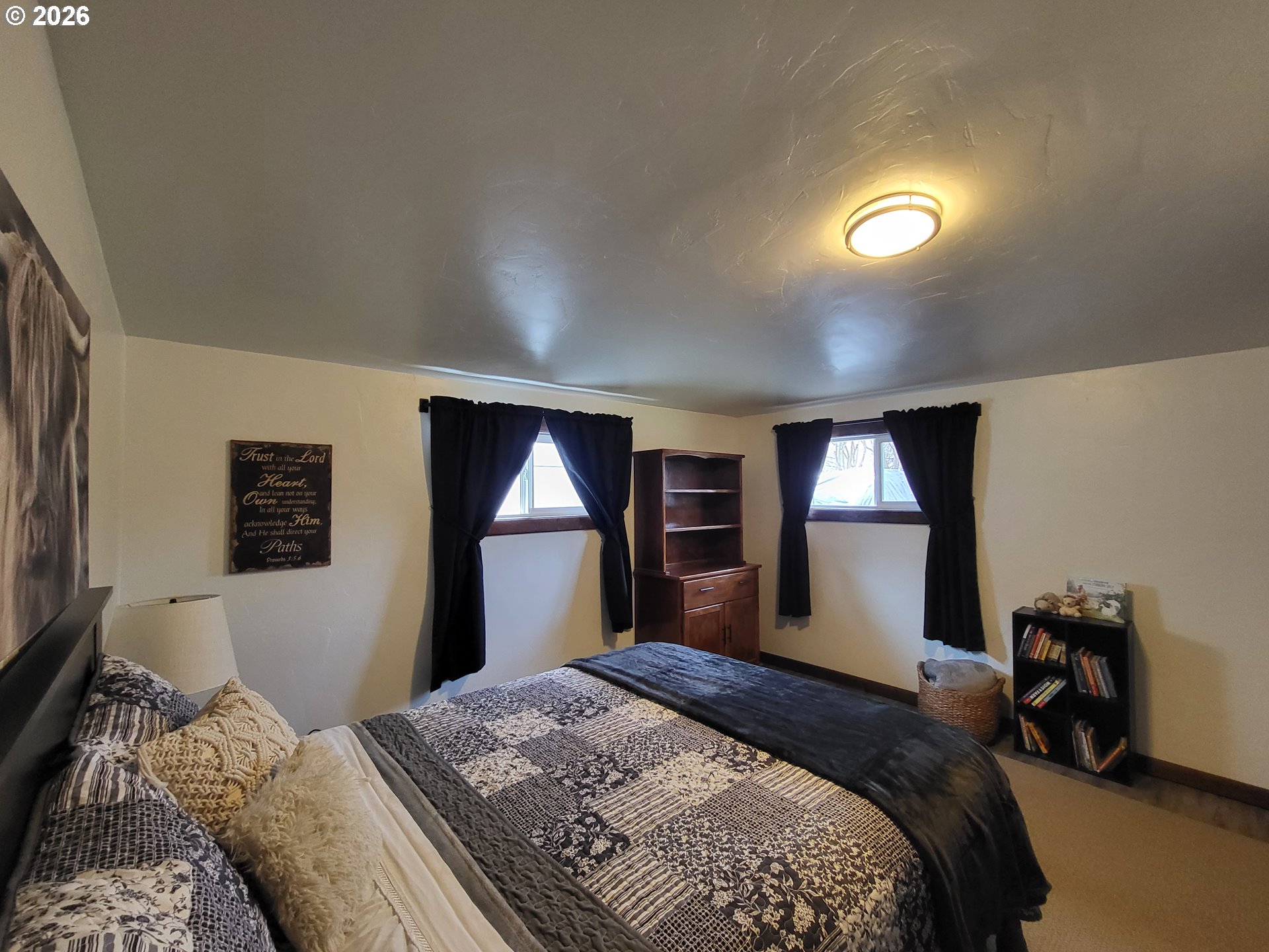 403 North Lake Street Joseph, OR 97846 - Photo 32 of 46 a bedroom with bed and a large mirror next to a window