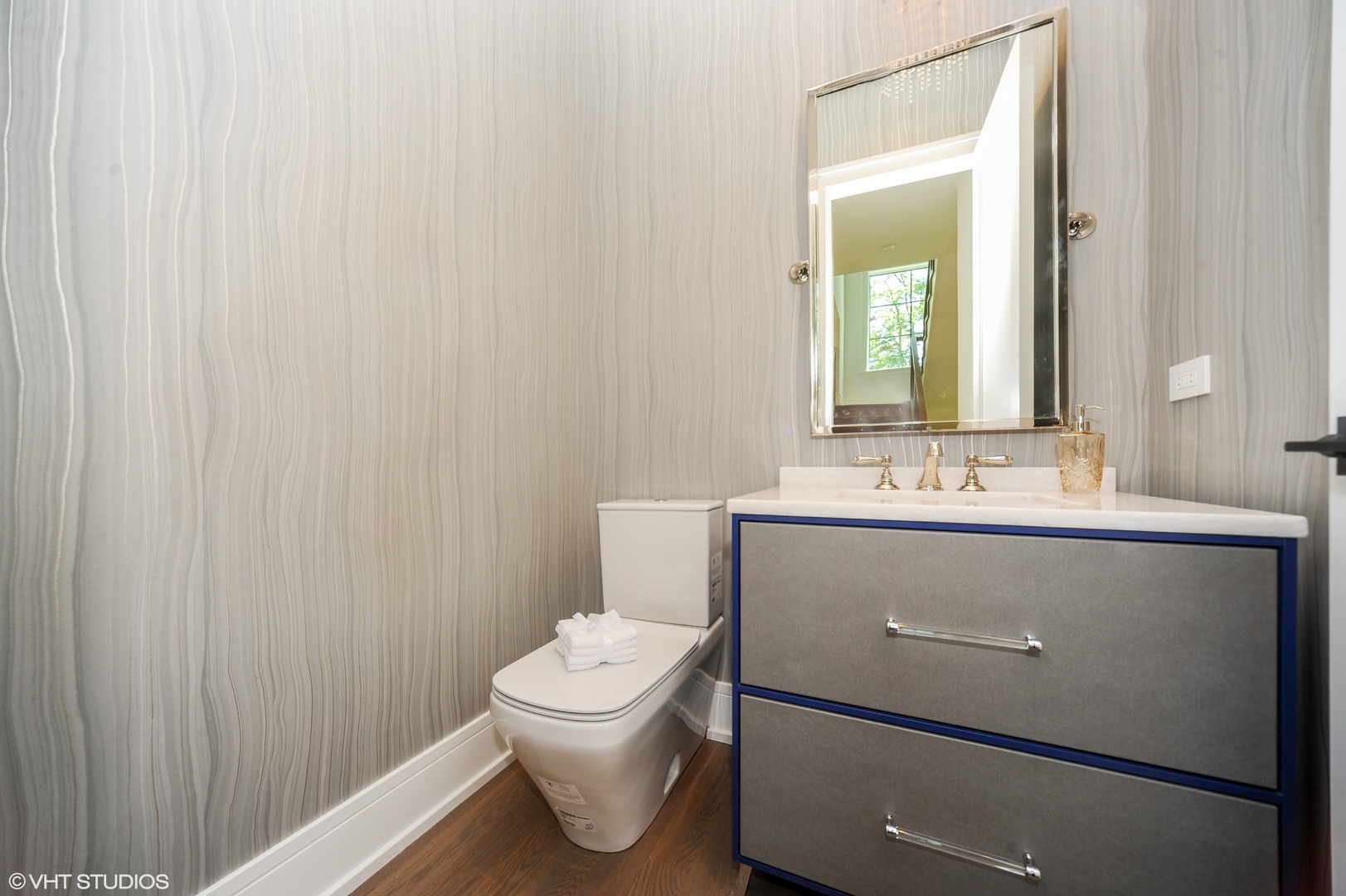 2440 Illinois Road Northbrook, IL 60062 - Photo 13 of 18 a bathroom with a sink a toilet and mirror