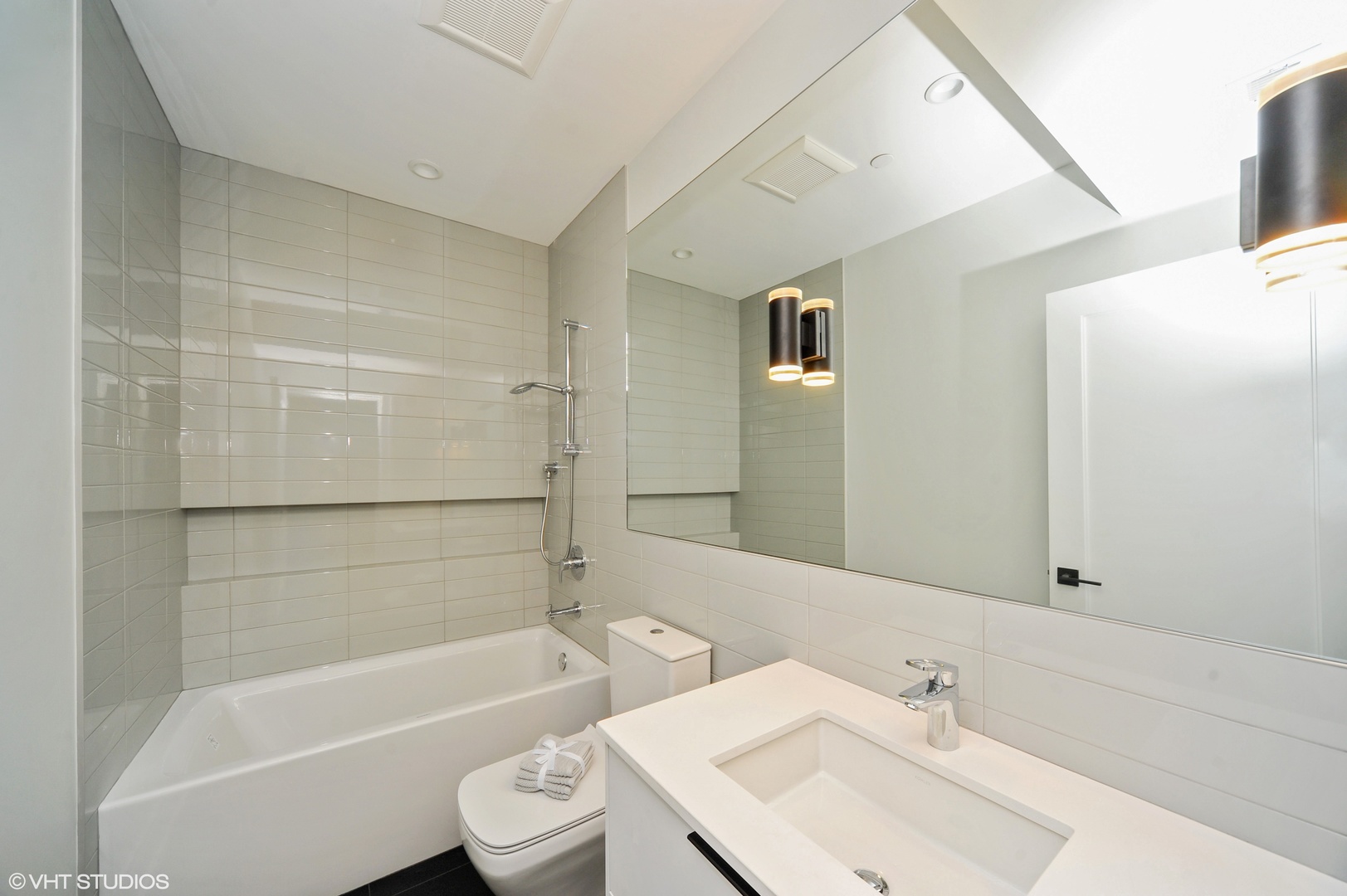2440 Illinois Road Northbrook, IL 60062 - Photo 16 of 18 a bathroom with a bathtub shower sink vanity and toilet