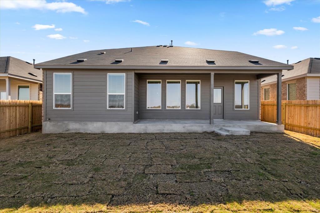 192 Rodney Boat Road Kyle, TX 78640 - Photo 36 of 38 A private backyard awaits, featuring a covered patio and a newly installed lawn.