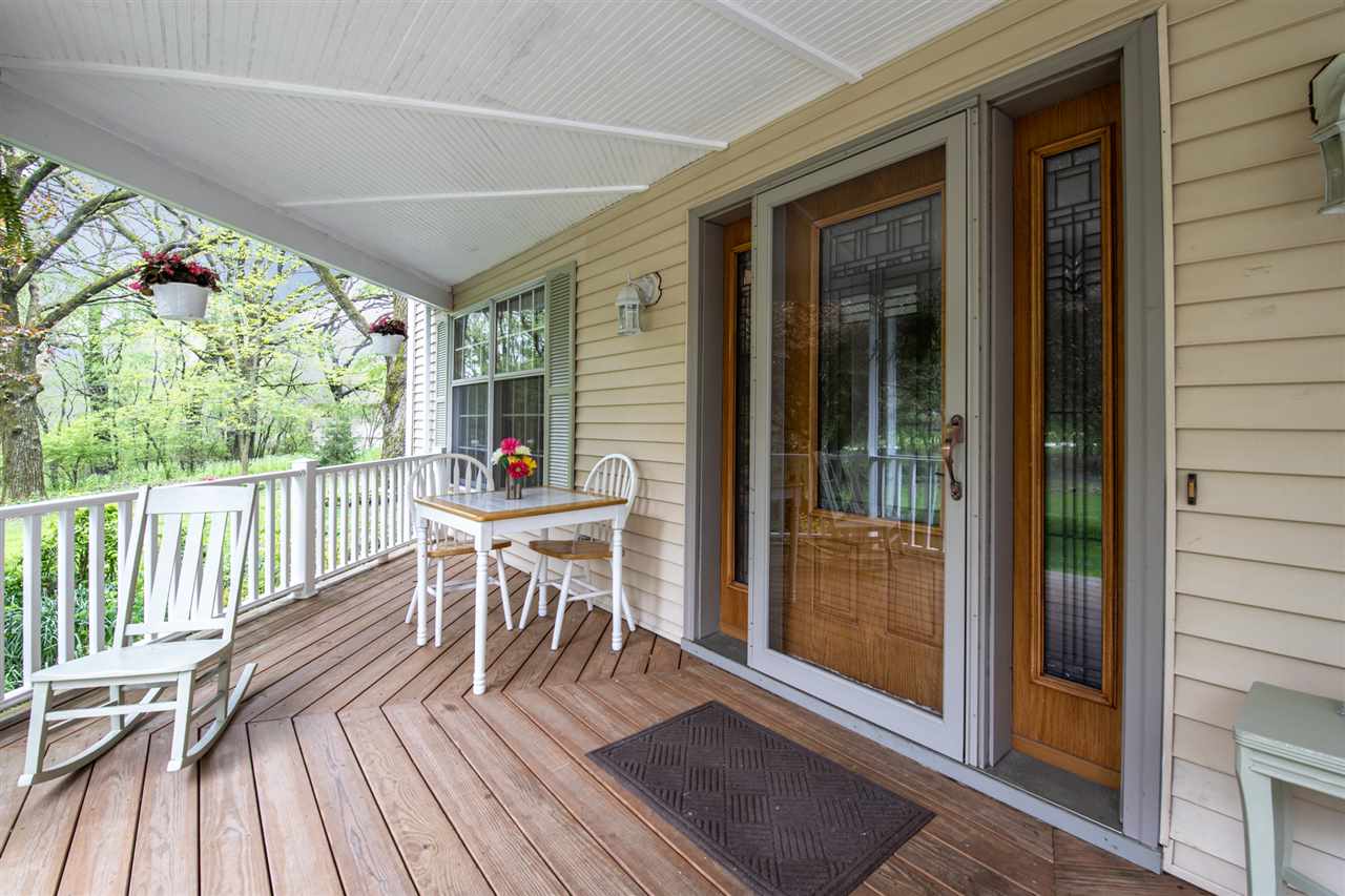 11900 Beloit Road Caledonia, IL 61011 - Photo 3 of 27 a dining room with wooden floor and outdoor space