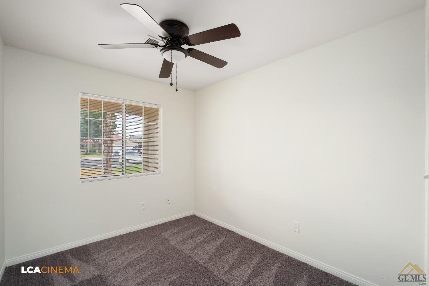 Undisclosed Address Bakersfield, CA 93308 - Photo 14 of 18 an empty room with a window and a fan