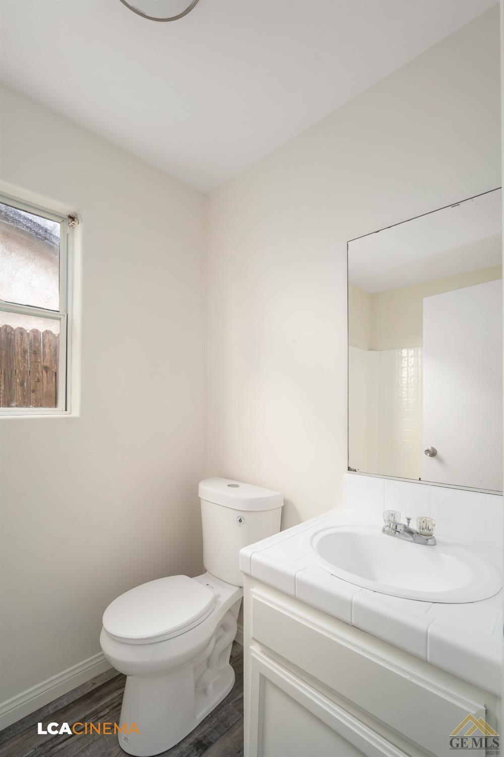 Undisclosed Address Bakersfield, CA 93308 - Photo 15 of 18 a bathroom with a sink a toilet and mirror