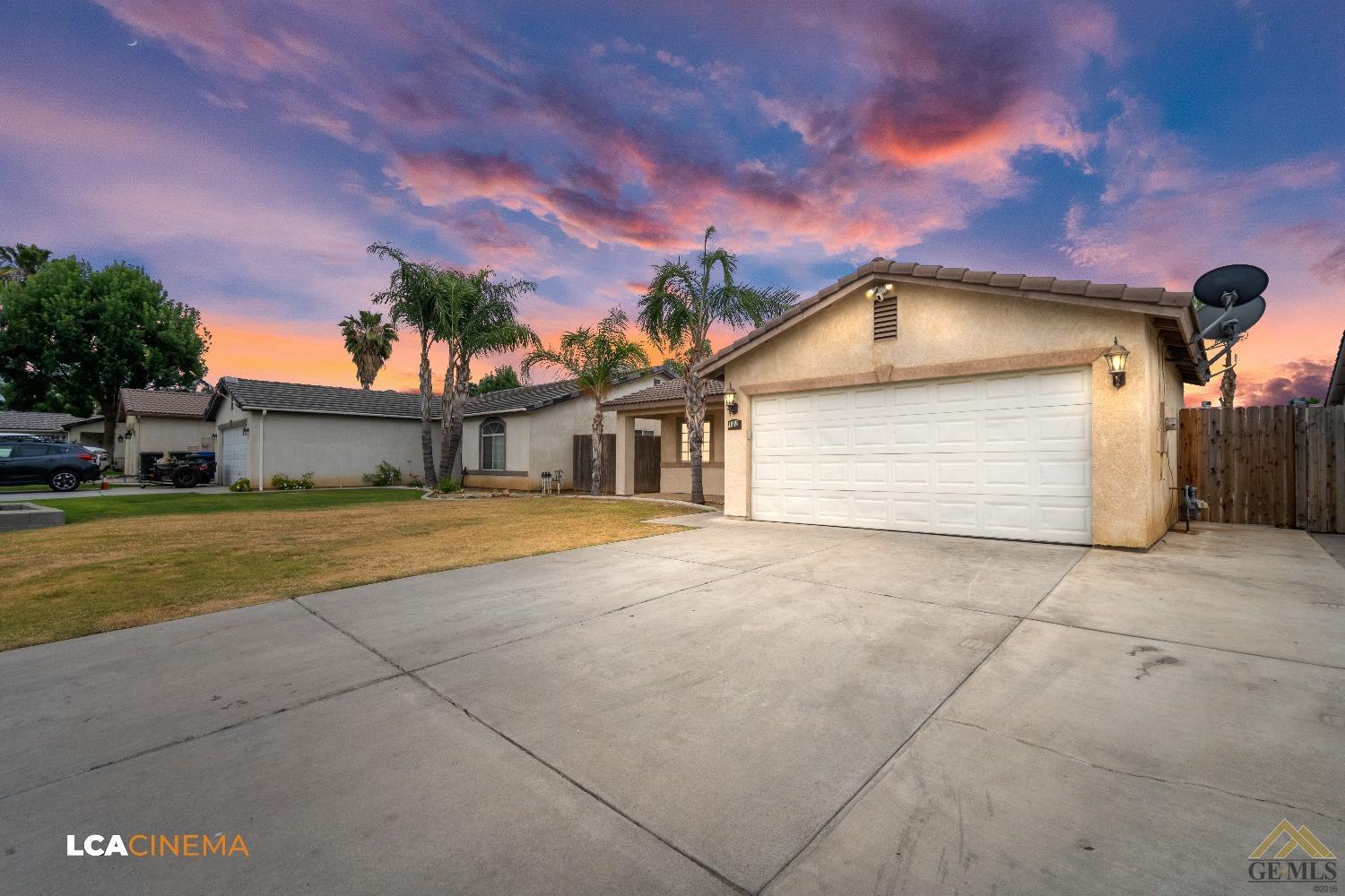 Undisclosed Address Bakersfield, CA 93308 - Photo 3 of 18 a front view of a house with a yard and garage