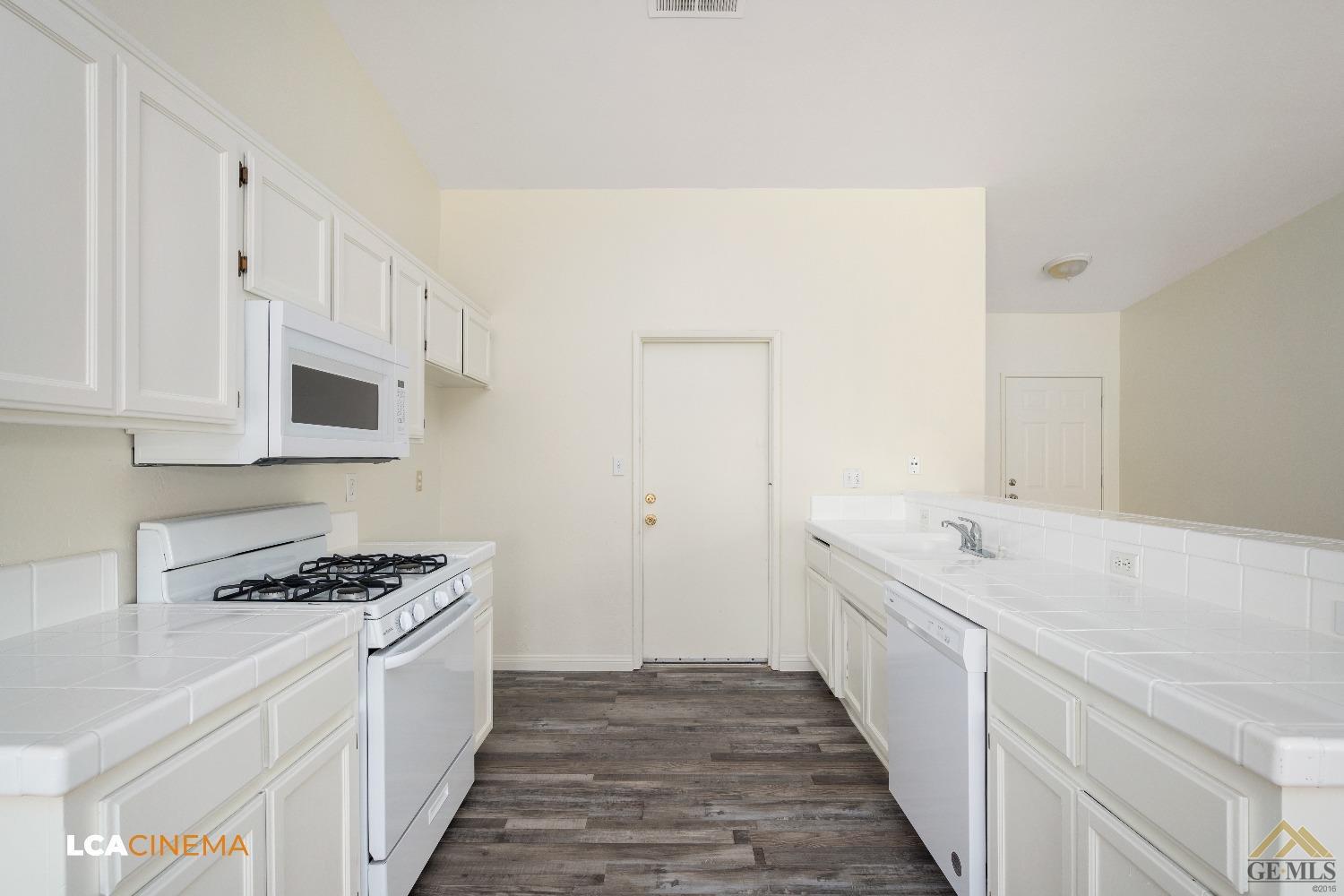 Undisclosed Address Bakersfield, CA 93308 - Photo 6 of 18 a kitchen with granite countertop a sink and cabinets