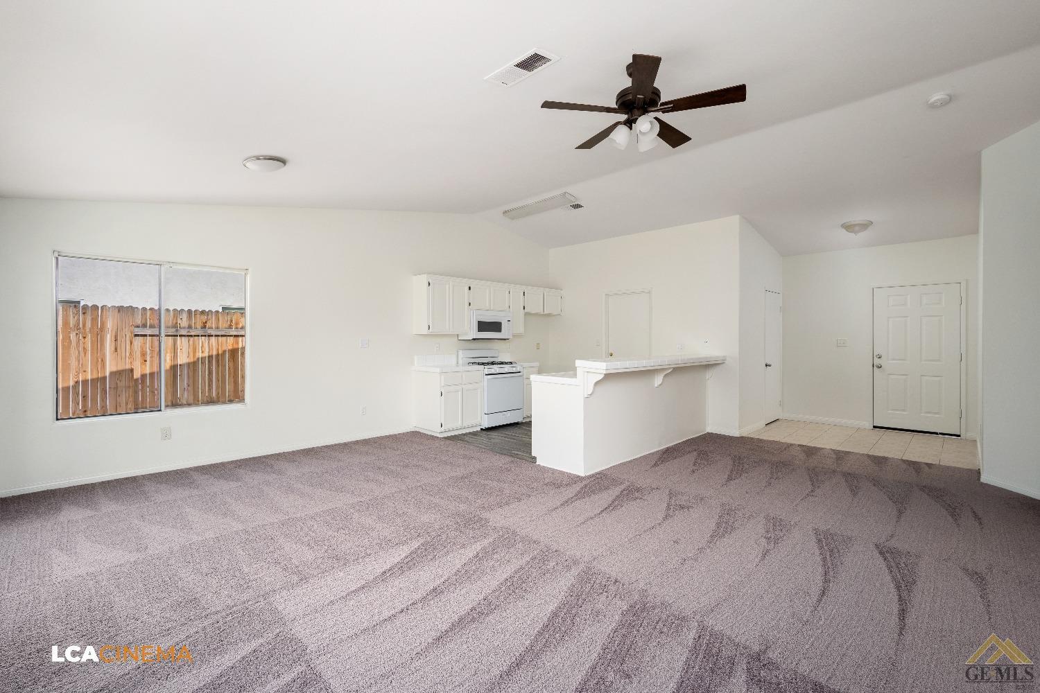 Undisclosed Address Bakersfield, CA 93308 - Photo 7 of 18 a view of a room with a kitchen island a sink wooden floor and a window