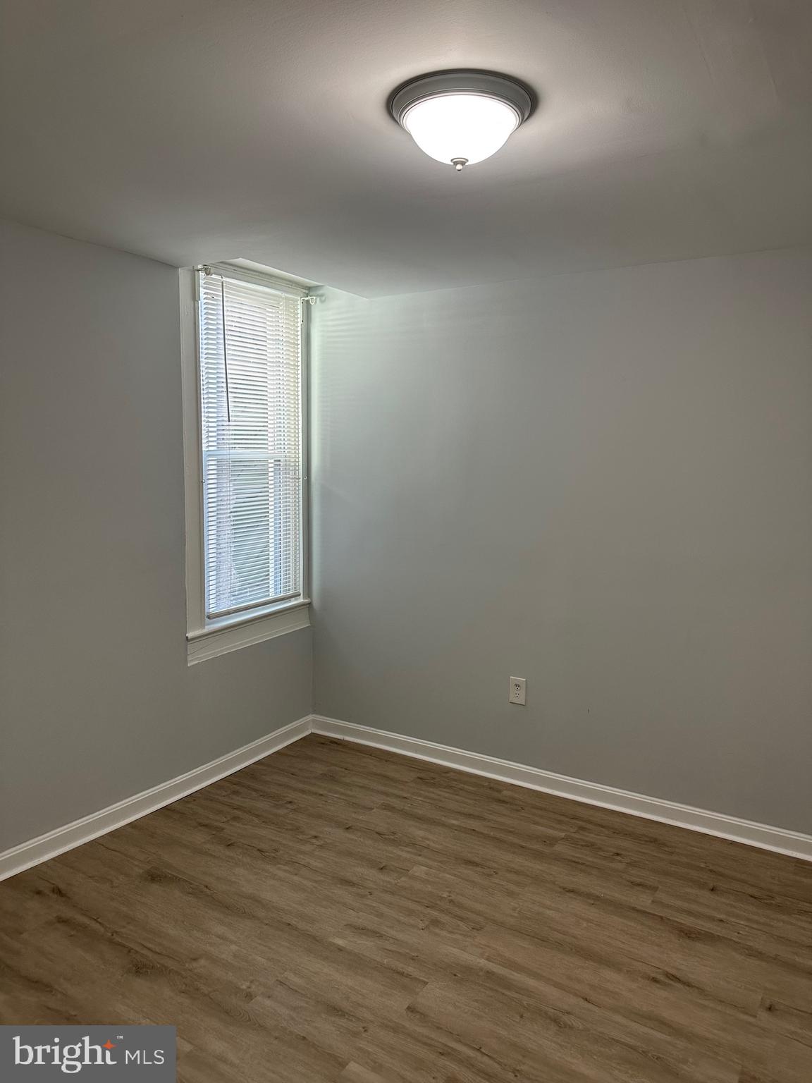 4331 Harford Road, Unit 2 Baltimore, MD 21214 - Photo 8 of 17 an empty room with wooden floor and windows