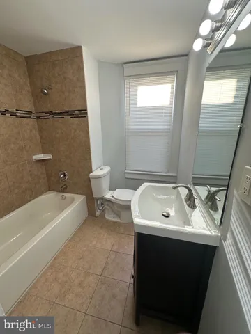 a bathroom with a sink a toilet and bathtub