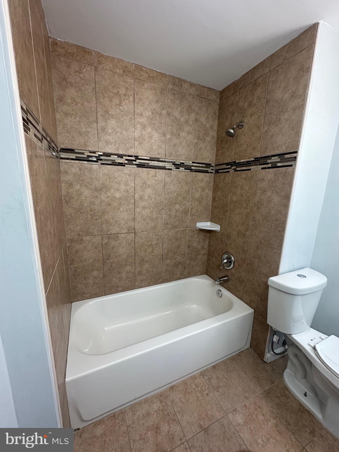 4331 Harford Road, Unit 2 Baltimore, MD 21214 - Photo 10 of 17 a spacious bathroom with a granite countertop sink toilet and a bathtub
