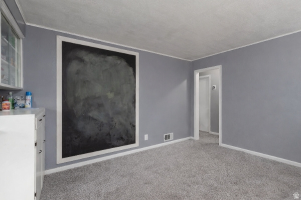 875 Patterson Street Ogden, UT 84403 - Photo 8 of 38 Unfurnished room with light carpet and crown molding