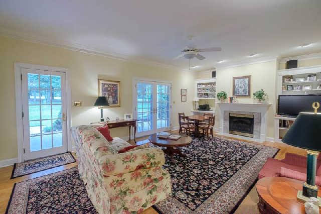 676 Pickney Road Winchester, TN 37398 - Photo 5 of 20 Cozy den with built ins and gas log fireplace as well as hardwood flooring