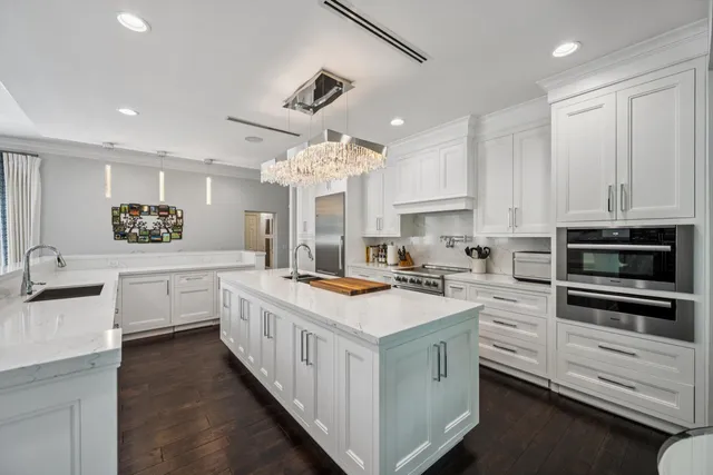 a kitchen with white cabinets and white appliances