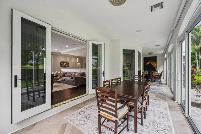 a living room with fireplace furniture and a large window