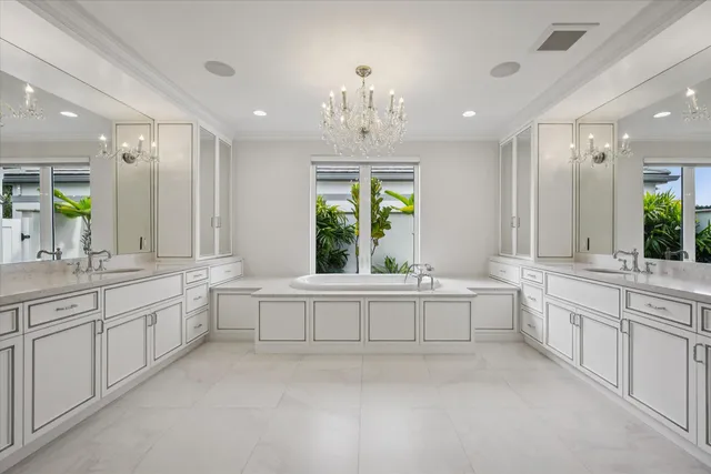 a large white bathroom with a large tub sink and vanity