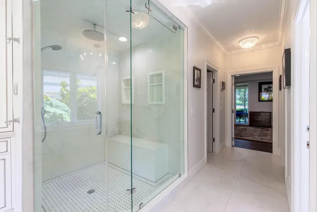 a bathroom with a glass shower door and a sink