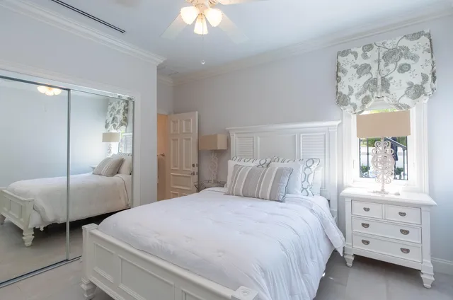 a bedroom with a bed and a mirror