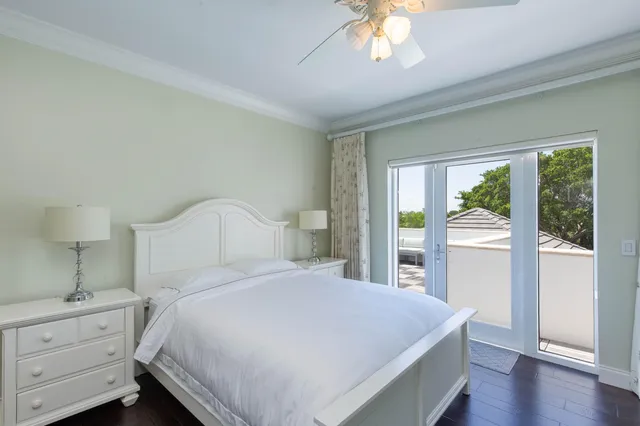a bedroom with a large bed and a chandelier