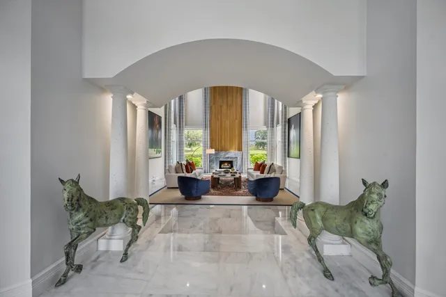 a living room with furniture and large windows