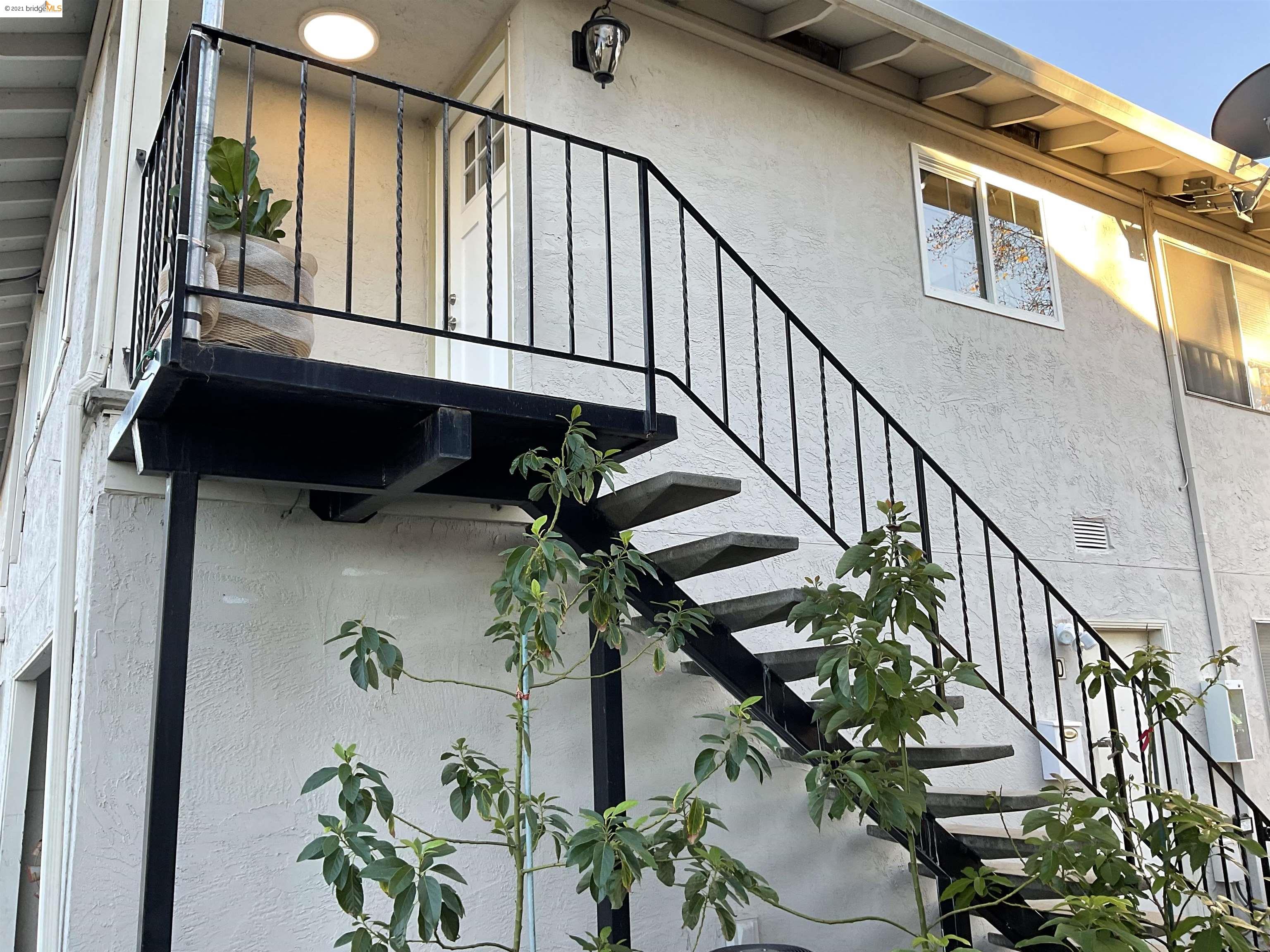 a view of staircase with wooden floor and a potted plant