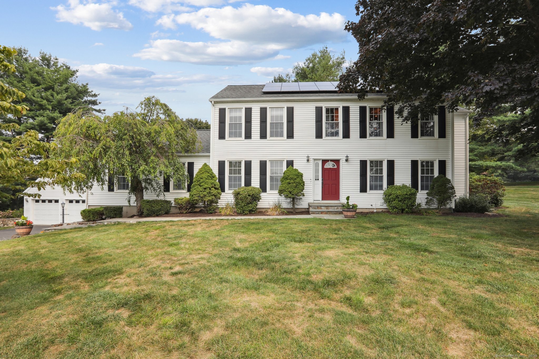 a front view of a house with a garden