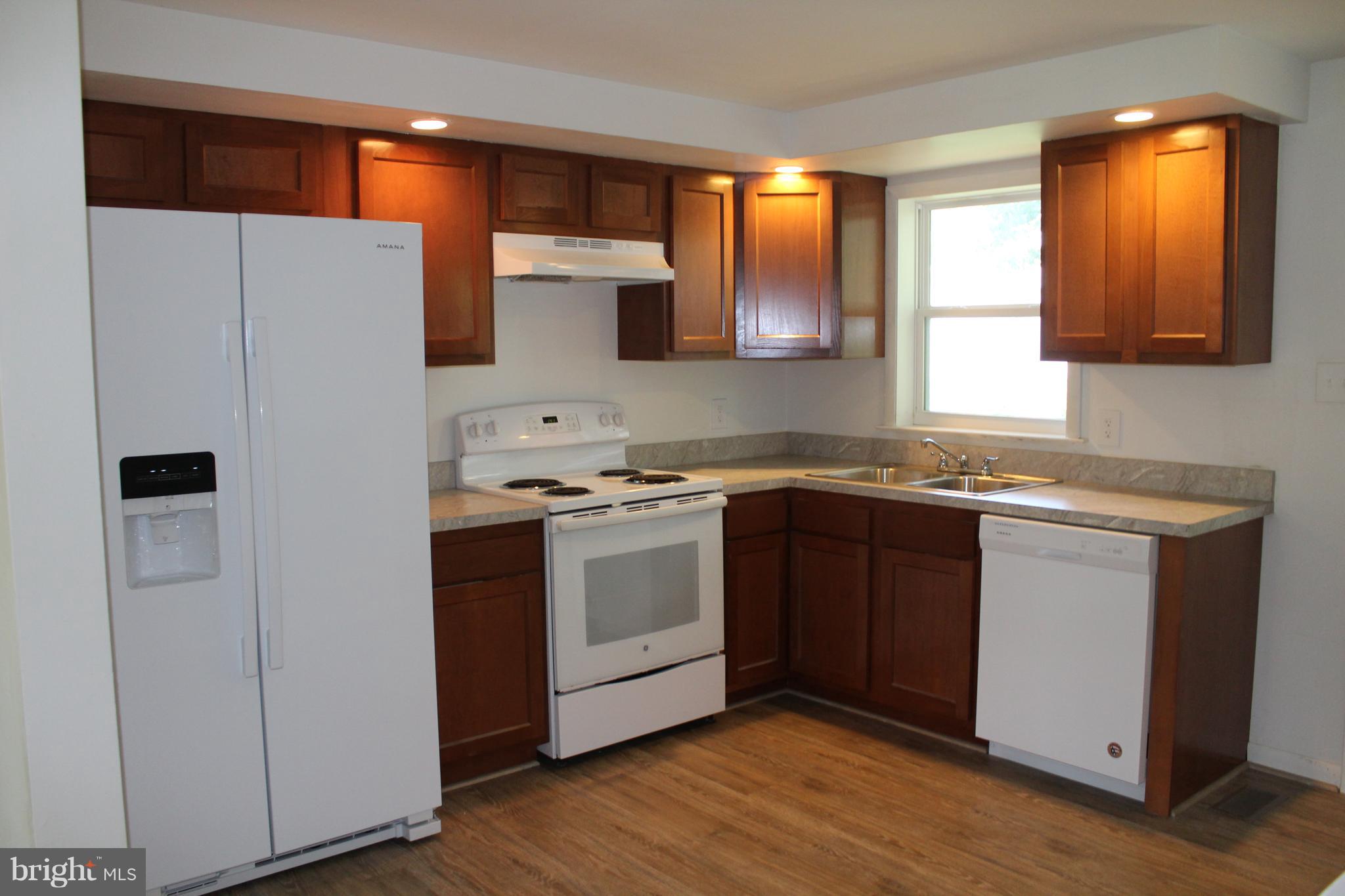 806 North Reymann Street Ranson, WV 25438 - Photo 13 of 25 a kitchen with stainless steel appliances granite countertop a refrigerator and a sink