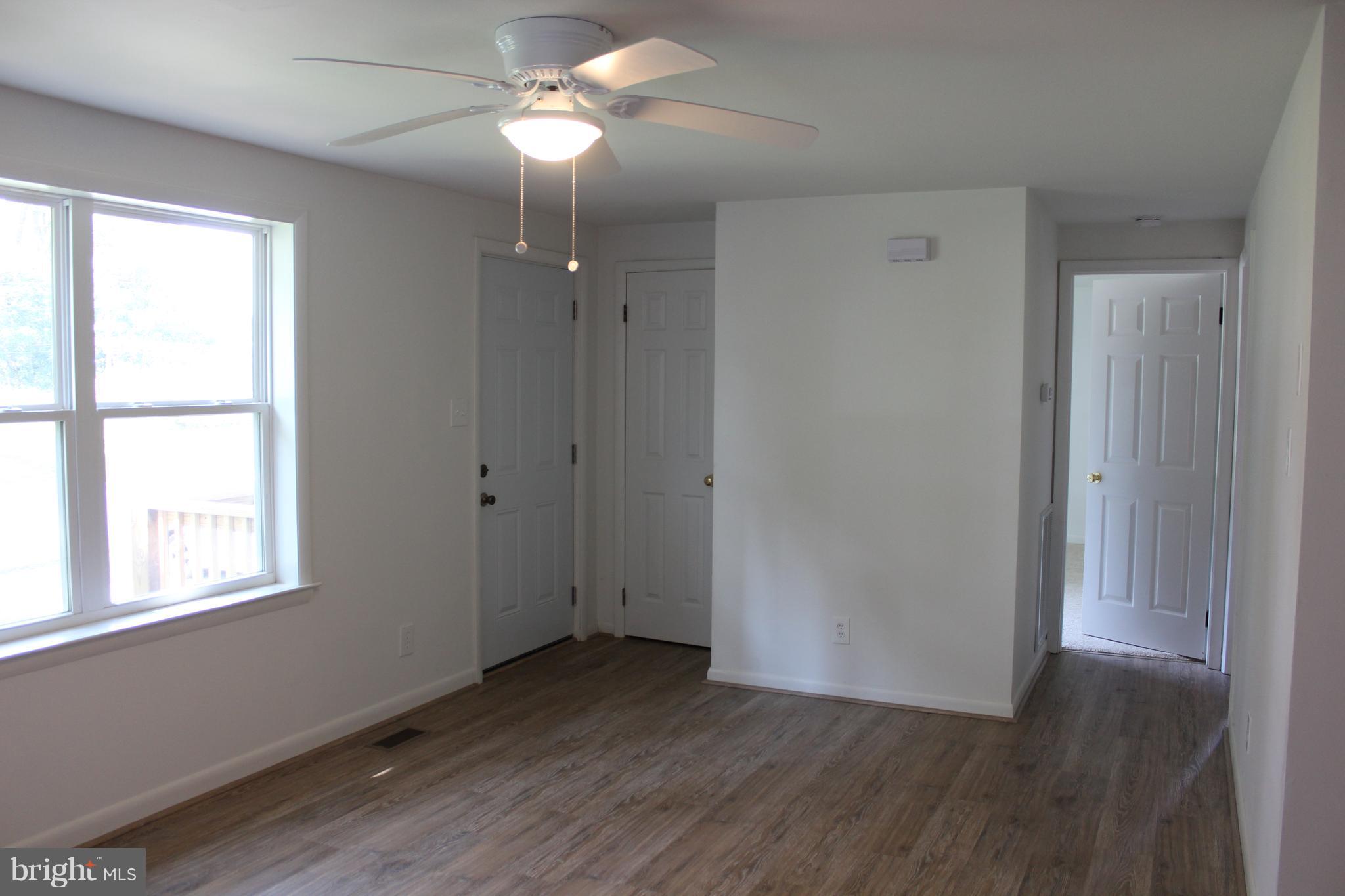 806 North Reymann Street Ranson, WV 25438 - Photo 5 of 25 wooden floor in an empty room with a window