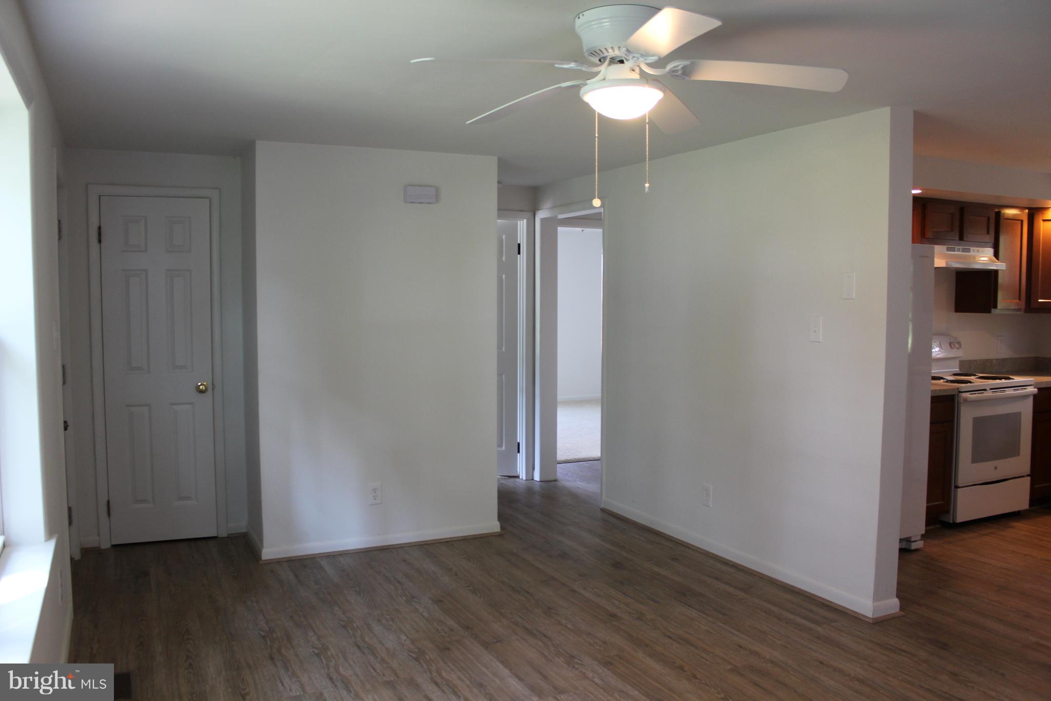 806 North Reymann Street Ranson, WV 25438 - Photo 6 of 25 an empty room with wooden floor a chandelier fan and closet area