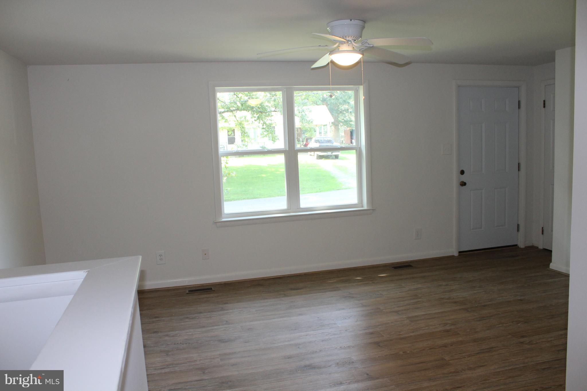 806 North Reymann Street Ranson, WV 25438 - Photo 8 of 25 a view of an empty room with wooden floor and a window