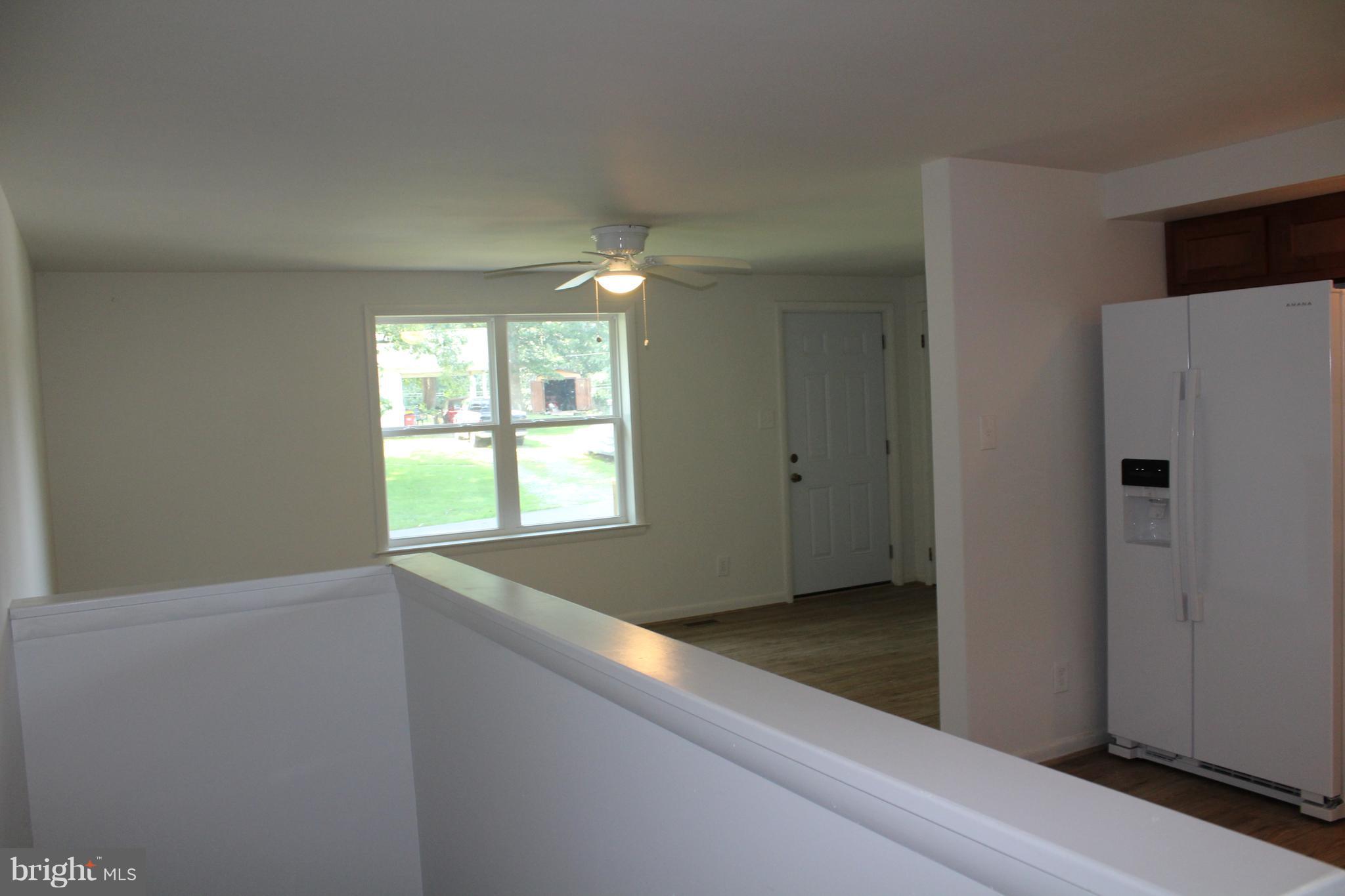 806 North Reymann Street Ranson, WV 25438 - Photo 9 of 25 a view of an empty room with wooden floor and a window