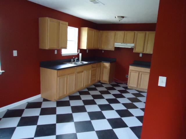 1076 Jacob's Valley Road Joelton, TN 37080 - Photo 12 of 20 a kitchen with a checkered floor and a black white checkered floor