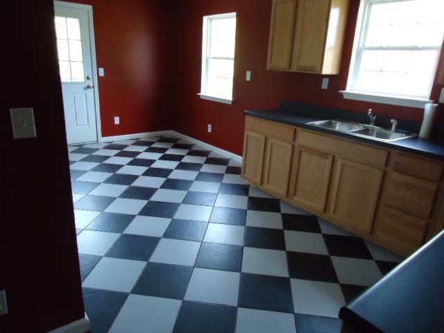 1076 Jacob's Valley Road Joelton, TN 37080 - Photo 13 of 20 a kitchen with a black white checkered floor and a sink