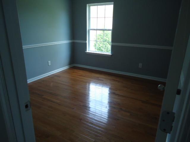 1076 Jacob's Valley Road Joelton, TN 37080 - Photo 17 of 20 an empty room with wooden floor and windows
