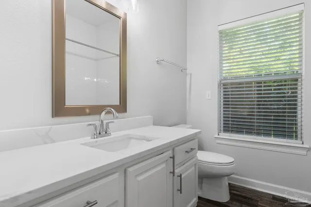 a bathroom with a sink a toilet and a mirror