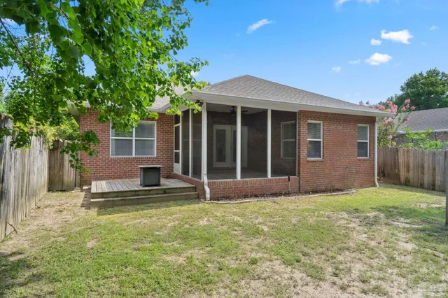 a view of a house with a yard and potted plants