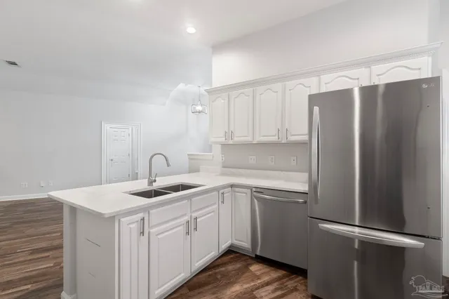 a kitchen with a sink appliances and cabinets