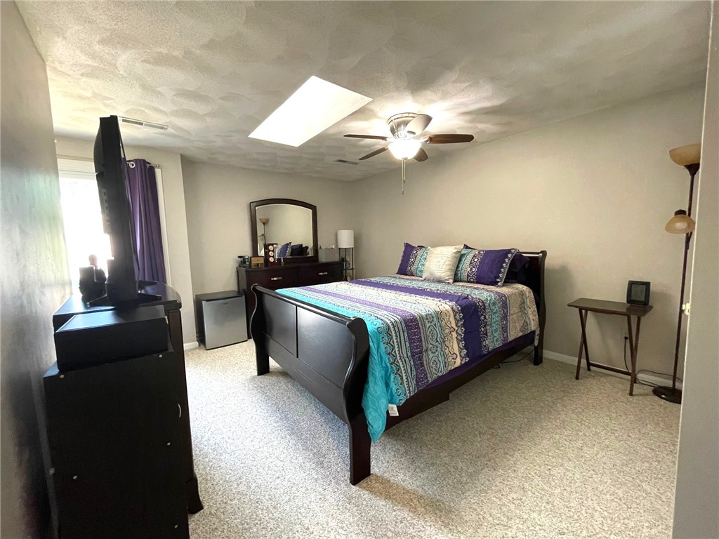 161 West Shore Road, Unit C7 Warwick, RI 02889 - Photo 23 of 36 The Primary Bedroom is oversized and offers a walk-in closet, skylight and a sitting area visible in another photo.